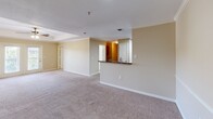 Located at 3606 Kaliste Saloom Rd in Lafayette, Louisiana, this one-bedroom, one-bathroom unit offers a practical and comfortable single-floor layout. The open-concept living and dining area flows seamlessly into the kitchen, which is equipped with rich, warm-toned wood cabinetry, granite-style countertops, stainless steel appliances, and a pass-through breakfast bar that connects the two spaces. Neutral-toned carpet spans the living area and bedroom, creating a cohesive and cozy feel throughout.

The bedroom is a generously sized retreat featuring dual windows that invite abundant natural light and offer views of surrounding greenery. A ceiling fan provides year-round comfort, and the room connects directly to the bathroom for added convenience. The bathroom includes a single-sink vanity, overhead cabinetry for ample storage, and a shower enclosure, all finished in light, neutral tones.

The living area also benefits from crown molding details and recessed lighting, adding a refined touch to the overall design. Additional spaces include a dedicated laundry area and a closet, enhancing the unit's functionality. The warm, tan wall palette carried throughout the home creates a welcoming and unified ambiance ideal for everyday living.