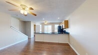 Located at 522 Blackstone Drive in Morgantown, WV, this well-appointed three-bedroom, four-bathroom home spans three floors and offers a thoughtfully designed layout with generous living space throughout. The main level features an open-concept kitchen and living area with rich hardwood-style flooring, ceiling fans, and abundant natural light from large windows and a sliding glass door leading to a balcony. The kitchen is highlighted by dark granite countertops, warm wood cabinetry, stainless steel appliances, and a peninsula that provides both workspace and a casual dining area. The living space is expansive, with dual ceiling fans and sliding door access to outdoor views. Connecting hallways are bright and clean, leading seamlessly between spaces. The bedrooms feature plush carpeting, ceiling fans, and ample closet space, while the spacious primary bedroom includes a private en-suite bathroom with warm wood cabinetry. The four bathrooms are clean and functional, with hardwood-style or tile flooring. Additional highlights include a dedicated game room, a laundry room with tile flooring, an attached garage with automatic opener, two balconies, and multiple staircases connecting each level. Neutral tones and consistent finishes throughout give the home a cohesive and move-in-ready feel.