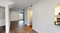 Located at 3167 Chestnut Dr in Doraville, GA, this two-story, 2-bedroom, 3-bathroom home offers a well-organized layout with equal living space distributed across both floors. The main level features an open living room with rich hardwood-style flooring, neutral-toned walls, and natural light from several windows. A staircase connects to the upper level, adding an airy sense of vertical space. The kitchen is outfitted with white shaker-style cabinetry, dark granite countertops, a stainless steel double-basin sink, and a window that fills the space with natural light. Each of the three bathrooms features white tile tub-shower combinations, dark granite vanity tops, and clean, bright finishes. The two bedrooms are carpeted for comfort and each includes a ceiling fan with light fixture. The spacious primary bedroom offers natural light through a window and convenient walk-in closet access. The secondary bedroom features dual bi-fold closets alongside an additional shelved storage closet, providing ample storage. A hallway connects the upper-level rooms efficiently. Throughout the home, clean white walls and consistent finishes create a cohesive, move-in-ready atmosphere.