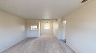 Located at 2800 S 25th St in Abilene, Texas, this 2-bedroom, 1-bathroom unit offers a practical and well-organized single-floor layout. The living room greets you at the entry with neutral-toned carpet, a textured ceiling, and a front-facing window that brings in natural light, creating a bright and comfortable gathering space. Adjacent to the living area, the galley-style kitchen features wood-look flooring, gray cabinetry, white appliances including a range and refrigerator, a built-in dishwasher, and a sink with counter space on both sides — maximizing efficiency in a compact footprint. Both bedrooms are carpeted and feature ceiling fans with light fixtures and windows with blinds, providing ample ventilation and natural light. The primary bedroom is a well-sized retreat with its own walk-in closet, which is outfitted with built-in shelving units and hanging rods, offering generous storage options. The full bathroom features wood-look flooring, a tub-shower combo, vanity, and toilet, all finished in a clean, bright palette. A connecting hallway ties the rooms together seamlessly. Throughout the unit, textured ceilings, neutral walls, and consistent flooring choices create a cohesive and move-in-ready atmosphere.