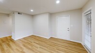 Located at 3020 Cottage Pl in Greensboro, NC, this one-bedroom, one-bathroom unit offers a thoughtfully organized single-floor layout with a clean, neutral aesthetic throughout. The entry area welcomes you with light wood-tone flooring and recessed lighting, setting a bright, modern tone. The open-concept living room flows seamlessly from the entry and is filled with natural light from multiple windows dressed with blinds, offering pleasant outdoor views of surrounding greenery. The galley-style kitchen is a functional highlight, featuring white cabinetry, granite-look countertops, stainless steel appliances including a refrigerator and dishwasher, and a double-basin sink — all illuminated by overhead panel lighting and complemented by the same wood-tone flooring. A dedicated pantry closet provides convenient additional storage just off the kitchen. The bedroom offers comfortable carpeted flooring, a window with natural light, and direct access to a hallway closet with louvered doors. The full bathroom is finished with wood-tone flooring and includes a shower-tub combination. A connecting hallway ties the spaces together efficiently, completing a compact yet well-equipped home.