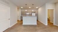 This single-story residence at 1100 Sugarbush Dr, Ashland, OH, offers a contemporary living space with a thoughtful layout. The home features an open floor plan, seamlessly connecting the kitchen, dining, and living areas. The kitchen is equipped with white appliances, including a refrigerator, stove, and microwave, complemented by light-colored cabinetry and granite countertops. A combination of flooring types is used throughout, with wood-look laminate in main living areas and plush carpeting in bedrooms.

The bedrooms are generously sized, featuring ceiling fans and large windows that allow natural light to flood the space. A walk-in closet provides ample storage. The bathroom boasts a double vanity with a large mirror, modern lighting fixtures, and a clean, neutral color scheme.

The living room is spacious, with a ceiling fan and multiple windows offering views of the outdoors. Throughout the home, recessed lighting and modern fixtures provide bright, even illumination. The overall design aesthetic is clean and neutral, creating a blank canvas for personalization while maintaining a contemporary feel.