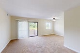 Located at 5902 31st Ave in Hyattsville, MD, this two-bedroom residence offers a well-organized single-floor layout designed for comfortable everyday living. The living room serves as the heart of the home, featuring plush wall-to-wall carpeting, a ceiling fan, and generous natural light provided by a large sliding glass door that opens onto a private balcony with views of lush greenery. A secondary window further brightens the space, creating an open and airy atmosphere throughout.

The galley-style kitchen is both functional and stylish, equipped with warm honey-toned wood cabinetry, dark granite countertops, black appliances including a gas range and refrigerator, and light hardwood-style flooring that contrasts nicely with the cabinetry.

The primary bedroom is generously sized, offering a ceiling fan with light fixture, a wide window dressed with blinds for natural light and privacy, and access to a dedicated closet. The second bedroom mirrors this comfortable design with carpeted flooring, a ceiling fan, natural light from a window, and a built-in closet with shelving. A connecting hallway ties the rooms together efficiently, with two closets providing ample storage throughout the unit.