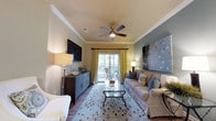 Located at 2222 Crow Ln in Myrtle Beach, SC, this single-floor residence offers a thoughtfully designed open-concept layout with warm, neutral tones throughout. The kitchen is a standout feature, showcasing rich wood cabinetry, granite-style countertops, a double-basin sink, pendant lighting, and a full suite of black appliances including a refrigerator, range, microwave, and dishwasher. A peninsula counter connects the kitchen seamlessly to the surrounding living areas, enhancing the flow of the space. Crown molding adds a refined architectural touch to the kitchen and adjoining areas. The dining area accommodates generous seating and is anchored by a striking drum pendant light, with soft sage-toned walls and tasteful wall art contributing to a relaxed coastal ambiance. The living area features a ceiling fan and access to an outdoor view. The bedrooms are carpeted for comfort, each featuring ceiling fans, walk-in closets, and soft green accent walls that create a serene retreat. Both bathrooms are finished with granite-topped vanities, wood cabinetry, tub-shower combinations, and wood-look flooring, offering a consistent and cohesive design aesthetic. Throughout the residence, durable wood-look flooring ties the main living spaces together, creating a warm and inviting atmosphere ideal for coastal living.