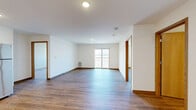 Located at 1820 Huntington Park Dr in Reedsburg, Wisconsin, this single-floor, two-bedroom, two-bathroom home offers a clean, modern design with consistent light-toned vinyl plank flooring and crisp white walls throughout. The well-appointed kitchen features light wood cabinetry, granite-style countertops, and a full suite of stainless steel appliances including a refrigerator, range, and dishwasher, all illuminated by recessed ceiling lighting. Adjacent to the kitchen, additional cabinetry and counter space provide practical storage and workspace. The spacious primary bedroom offers generous proportions, a large window framing outdoor views, and access to a private bathroom with light wood vanity, granite-style countertop, and a dedicated walk-in closet complete with built-in hanging rods. The second bedroom includes a built-in closet with wood bi-fold doors and connects conveniently to the main living areas. A second full bathroom continues the home's cohesive design with matching cabinetry and countertops. Notably, one bathroom includes an in-unit washer and dryer, adding everyday convenience. Throughout the home, warm wood-toned trim and doors complement the neutral palette, creating a bright, welcoming atmosphere.