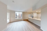 Located at 2111 Packard St in Ann Arbor, MI, this well-designed 2-bedroom, 2-bathroom unit offers a clean, modern aesthetic across a thoughtfully organized single-floor layout. Light wood-look flooring flows throughout the main living areas, complementing the bright, neutral palette that defines the space.

The open-concept kitchen is a standout feature, showcasing a combination of white upper cabinets and warm wood-toned lower cabinetry, stainless steel appliances including a full-size refrigerator, range, microwave, and dishwasher, and a peninsula with pendant lighting that connects seamlessly to the combined dining and living area. A large window in the living space allows ample natural light and provides views of the surrounding urban streetscape.

Both bathrooms are finished with crisp white tile, black-framed glass shower enclosures, and white vanities with matte black hardware, giving them a contemporary and polished feel. The bedrooms are carpeted for comfort, bathed in natural light through generously sized windows, and each benefits from dedicated closet space — including walk-in closets with built-in wire shelving systems. The unit also includes a laundry area and utility room, adding everyday convenience. Three total closets provide ample storage throughout.