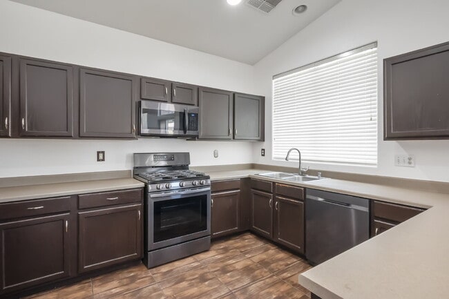 Building Photo - Charming single-story townhome featuring two bedrooms, two bathrooms, and an attached two-car gar...