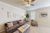 Located at 10720 Linkwood Ct in Baton Rouge, Louisiana, this single-story, 2-bedroom, 2-bathroom residence offers a well-organized layout with a welcoming entrance that leads into a spacious living area. The living room features soft carpet flooring, elegant crown molding, a ceiling fan, and large windows that allow natural light to fill the space, creating a bright and airy atmosphere. The living area flows seamlessly into a combined dining room and kitchen, providing a practical open-concept design ideal for daily living and entertaining.

The primary bedroom is a comfortable retreat, complete with a ceiling fan, carpeted floors, a generous closet, and a window overlooking the outdoors. The second bedroom also features an arched window with natural views, a ceiling fan, and its own closet space, offering versatility as a guest room or home office. Both bathrooms are well-appointed, with one featuring wood-look flooring and a dual-sink vanity with ample counter space and a large mirror.

Additional highlights include five closets for exceptional storage, a dedicated laundry area, a hallway connecting the main rooms, and a private patio perfect for outdoor relaxation. The neutral color palette throughout lends the space a clean, cohesive feel.