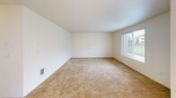 Located at 4909 E Upriver Dr in Spokane, WA, this 2-bedroom, 2-bathroom single-floor unit offers a practical and comfortable layout. The combined kitchen and living area serves as the heart of the home, with the kitchen featuring light maple cabinetry, laminate countertops, tile flooring, a white electric range, refrigerator, and a stainless steel sink. The adjacent living room is carpeted and receives natural light through a large window with blinds, creating a bright and open atmosphere.

Both bedrooms are carpeted and offer a clean, neutral palette with windows that bring in natural light. The spacious primary bedroom includes a generous walk-in closet outfitted with wire shelving on multiple walls, providing ample storage. The second bedroom is well-sized and similarly bright.

The two bathrooms are finished with tile flooring and light maple vanity cabinetry with laminate countertops. One bathroom features a tub/shower combo with a large mirror and a strip of vanity lighting above the sink, while the second bathroom provides additional convenience for guests or residents. A hallway connects the main living spaces to the bedrooms and bathrooms, contributing to a well-organized flow throughout the unit.