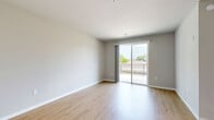 Located at 5033 Old Middleton Rd in Madison, WI, this well-appointed one-bedroom, one-bathroom unit offers a thoughtfully designed layout across a single floor. The open-concept kitchen and living area serves as the heart of the home, featuring granite countertops, white shaker cabinetry with matte black hardware, stainless steel appliances, and warm wood-look flooring. Stylish pendant lighting illuminates the kitchen's peninsula, which provides both prep space and a casual dining option. The living area extends naturally toward a sliding glass door that opens onto a private balcony with black metal railings and tile flooring, offering pleasant outdoor views of surrounding greenery. The bedroom is a comfortable, carpeted retreat with a ceiling fan, a window overlooking the outdoors, and direct access to a dedicated walk-in closet equipped with built-in shelving and hanging rods. The full bathroom features granite countertops on a blue-toned vanity, wood-look flooring, a tub-shower combination, and a large window that fills the room with natural light. Neutral gray tones and clean white trim carry throughout the unit, creating a cohesive, modern aesthetic well-suited to a variety of lifestyles.