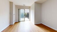 This efficiently designed 1-bedroom, 1-bathroom unit offers a thoughtful single-floor layout encompassing a living room, bedroom, kitchen, bathroom, and pantry. Warm-toned hardwood-style flooring flows consistently throughout the space, lending a cohesive and inviting feel to every room.

The living area is bright and open, highlighted by a sliding glass door that connects to an outdoor area, allowing natural light to fill the room and providing convenient access to the exterior. The bedroom is a well-proportioned private retreat featuring dual windows that bring in additional natural light and views of the surroundings.

The kitchen is practical and well-equipped, featuring white cabinetry with ample upper and lower storage, granite-look countertops, a stainless steel sink, a dishwasher, and a tiled backsplash. A dedicated pantry provides further storage convenience.

The bathroom includes a full soaking tub with a tiled surround accented by neutral beige stripe detailing, complemented by stainless steel grab bars and a handheld showerhead, offering both style and accessibility.

Throughout the unit, neutral gray-white walls, flush-mount lighting, and clean white baseboards create a fresh, modern ambiance that is move-in ready and easy to personalize.
