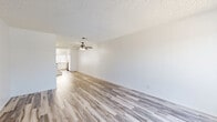 This two-story, 3-bedroom, 3-bathroom home on Zelzah Avenue in Encino, Los Angeles offers a well-organized layout spread across two floors. The main level features two living areas, both bright and open, with light wood-style vinyl flooring and ceiling fans that contribute to a clean, airy atmosphere. The kitchen is outfitted with white cabinetry, warm-toned countertops, stainless steel appliances including a dishwasher, range, and microwave, and a double basin sink beneath a window. A staircase with a modern railing connects the floors, and in-unit laundry with a stacked washer/dryer and full-size refrigerator adds everyday convenience. The three bathrooms feature light wood-style flooring, white vanities, and clean finishes; one includes a tub-shower combo with sliding glass doors. Upstairs, the bedrooms are carpeted and well-lit by windows with vertical blinds that allow natural light while maintaining privacy. The generously sized primary bedroom provides a comfortable retreat. Throughout the home, a neutral color palette of whites and soft beiges creates a cohesive, move-in-ready feel suited for comfortable everyday living in a prime Los Angeles location.