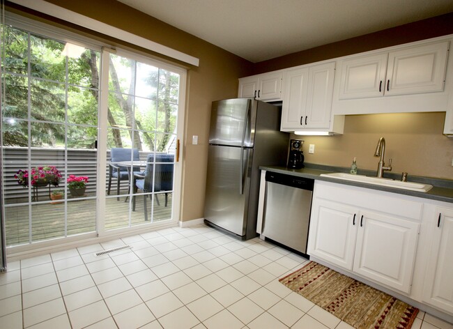 Bright kitchen that walks out to the side patio. - 15805 24th Ave N.