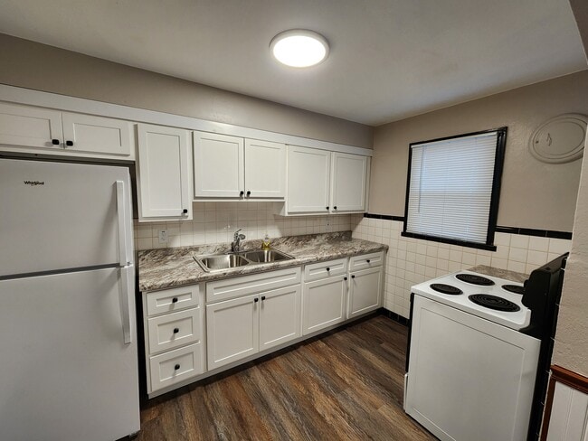 Kitchen with electric stove and refrigerator - 13131 East Ln
