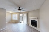 This one-bedroom, one-bathroom unit at 101 S Twin Creek Dr in Killeen, TX offers a thoughtfully laid-out single-floor design. The living room serves as the heart of the home, highlighted by a tile-surround fireplace with a white mantel, light wood-style flooring, and a ceiling fan overhead. A sliding glass door opens to a private balcony, allowing natural light to fill the space, while a window with blinds adds to the bright, airy atmosphere. The textured ceiling adds a classic touch throughout.

The galley-style kitchen is well-appointed with crisp white cabinetry, black hardware accents, granite-look countertops, a subway tile backsplash, a stainless steel sink, and black appliances including a refrigerator, dishwasher, and microwave. A dining area adjacent to the kitchen benefits from its own window overlooking the exterior.

The bedroom features neutral carpet flooring and a dedicated closet for storage. The bathroom includes a full tub-shower combo with large-format tile surround and wood-style flooring. A dedicated laundry area and hallway storage add practical convenience, making this unit a complete and functional living space.