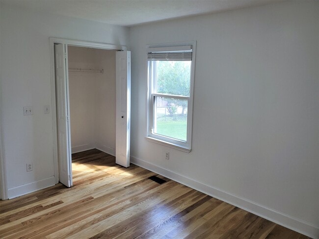 Third Bedroom contains a window overlooking the backyard, a small walk-in closet, and an attached bathroom. - 1025 Wade Ave