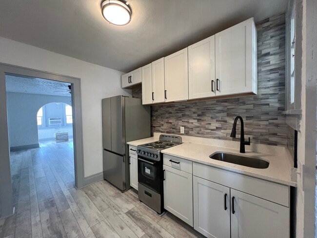 Kitchen with tile backsplash - 669 Avenue B NW