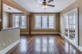 This well-appointed 1-bedroom, 1-bathroom residence in Memphis, TN (38104) offers a thoughtfully designed single-floor layout that blends classic character with modern updates. Rich, warm hardwood floors flow seamlessly throughout every room, anchoring the space with timeless appeal.

The living area is bright and inviting, featuring multiple windows with blinds that allow generous natural light to pour in, along with a ceiling fan for year-round comfort. A distinctive natural wood-framed pass-through opening connects the living space to the kitchen, adding an architectural detail that enhances the open feel.

The kitchen is well-equipped with dark espresso cabinetry, stainless steel appliances including a gas range, microwave, and refrigerator, complemented by recessed lighting and continued hardwood flooring.

The bedroom is spacious and airy, offering a large picture window with views of the surrounding neighborhood, exposed brick detailing along the base of one wall, a ceiling fan, and a built-in closet for storage.

The bathroom features classic white subway tile surrounding a full soaking tub and shower combination, accented by a black tile border and mosaic tile flooring, delivering a clean, timeless aesthetic. This residence offers a cohesive blend of character and functionality in a vibrant Memphis neighborhood.