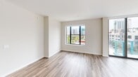 Located at 500 N Andrews Ave in the heart of downtown Fort Lauderdale, this modern 3-bedroom, 2-bathroom residence delivers a clean, contemporary aesthetic throughout. Wide-plank wood-style flooring flows seamlessly across the entire home, complemented by neutral walls and abundant natural light.

The open-concept kitchen and living area serves as the heart of the home, featuring sleek white cabinetry extending to the ceiling, a marble-style backsplash, stainless steel appliances, and a large central island with quartz countertops. Pendant lighting and a track light fixture add refined detail overhead, while expansive windows frame views of the surrounding cityscape.

The spacious primary bedroom offers floor-to-ceiling sliding glass doors opening to a private balcony with sweeping views of the Fort Lauderdale skyline. Two additional bedrooms are well-proportioned, each with large windows drawing in natural light and urban views. Two dedicated closets provide ample storage throughout.

Both bathrooms are finished with large-format marble-look tile flooring. The primary bath features a double vanity with backlit mirrors and warm wood cabinetry accents, while the second bath offers a similarly polished design with a single illuminated vanity. The overall ambiance is bright, modern, and move-in ready.