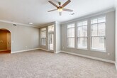 Located at 3838 N Braeswood Blvd in Houston, TX, this well-designed single-story residence offers 2 bedrooms and 2 bathrooms with a thoughtful, functional layout. The living room is bright and welcoming, featuring plush carpeting, crown molding, a ceiling fan with light fixture, and multiple large windows fitted with blinds that invite natural light while maintaining privacy. The kitchen is a standout, showcasing rich dark cabinetry with brushed nickel hardware, white countertops, a classic subway tile backsplash, stainless steel appliances, and crisp tile flooring. A convenient pantry and dedicated dining room add to the practicality of the space. The primary bedroom is generously sized, continuing the warm carpet and crown molding found throughout, and connects to a well-appointed en suite bathroom featuring dual vanity sinks with white countertops, tile flooring, and a glass-enclosed walk-in shower with grey tile surround. An expansive walk-in closet with wire shelving provides exceptional storage. The secondary bedroom also features carpet, a ceiling fan, and a bright window. A dedicated in-unit laundry room with full-size washer and dryer hookups, plus seven closets throughout, rounds out this highly functional and comfortable residence.
