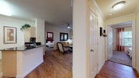 Located at 2417 Colorado St in Mission, TX, this single-floor residence offers a well-planned layout designed for comfortable everyday living. Wood-look flooring runs throughout the main living areas, lending warmth and visual continuity across the space.

The galley-style kitchen is outfitted with light cabinetry, dark granite countertops, a tile backsplash, and black appliances including a range, refrigerator, and built-in microwave. A peninsula counter provides a natural transition into the adjacent dining area, which features track lighting overhead and is large enough to accommodate a round dining table with seating for several guests.

The living room benefits from multiple windows dressed with drapes and blinds, allowing natural light to filter in, and includes a ceiling fan for added comfort. A glass door connects the living area to an outdoor space.

Two bedrooms provide private retreats, each with carpeted flooring, ceiling fans, and windows with blinds and curtain panels. The bedrooms offer ample room for full furniture arrangements.

A bathroom includes a wide vanity with dark countertop, a large mirror, and wood-look flooring. A dedicated laundry closet with washer and dryer hookups adds everyday convenience. The overall interior palette is neutral and bright, creating a clean and inviting atmosphere throughout.