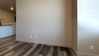 This 790 square foot apartment in Kalispell, Montana offers a blend of comfort and modern design. The space features two bedrooms, including a primary bedroom of 130 square feet, and two full bathrooms. The open-concept layout seamlessly integrates the kitchen and living area, maximizing the use of space.

The kitchen is a highlight, boasting dark wood cabinetry contrasted with light countertops and stainless steel appliances. It includes a built-in microwave and a stylish range, perfect for culinary enthusiasts. The living area is bathed in natural light from large windows that offer picturesque views of the surrounding neighborhood.

Throughout the apartment, you'll find high-quality vinyl plank flooring that mimics the warmth of hardwood while providing durability. The neutral color palette of the walls creates a versatile backdrop for various decor styles. Each room features ample closet space, ensuring plenty of storage options.

The bathrooms are designed with modern fixtures and clean lines, complementing the overall contemporary aesthetic of the apartment. The property also includes two dedicated closet areas, adding to the generous storage capacity.

Located at 41 Meridian Ct, this single-story apartment offers a perfect blend of functionality and style, ideal for those seeking a modern living space in Kalispell.
