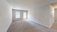 Located at 3668 McConnell Rd in Greensboro, NC, this single-floor residence offers a practical and well-organized layout with two bedrooms and two full bathrooms. The kitchen is equipped with rich dark-stained cabinetry, granite-look countertops, tile flooring, and black appliances including a dishwasher, range, and refrigerator. It flows seamlessly into the living room, which features soft carpeting, neutral-toned walls, and a glass-panel door alongside a window that invites natural light. Both bathrooms include tub-shower combos with clean white surrounds, tile flooring, and dark wood vanities with granite-style countertops. The spacious primary bedroom includes a ceiling fan, a window with natural light, and a dedicated closet with built-in wire shelving and hanging rods. The second bedroom is generously sized with plush carpeting and ample wall space. A walk-in closet with wire rack storage provides convenient organization. Throughout the residence, a consistent neutral color palette and clean finishes create a cohesive, move-in-ready atmosphere well-suited for comfortable everyday living.
