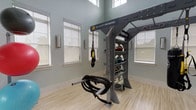 This single-floor Yoga & TRX Training Studio is thoughtfully designed to support both focused fitness and relaxed socializing. The dedicated training zone features soaring ceilings with clerestory windows that flood the space with natural light, accentuating the soft sage-green walls and light hardwood-style flooring. A professional TRX functional training rig anchors the room, complete with suspended straps, battle ropes, and a fully stocked equipment shelf, providing everything needed for a comprehensive bodyweight and resistance workout.

A glass-paneled entry corridor with polished concrete floors connects the training area to the broader facility, creating a seamless, open flow. The lounge and gathering area continues the polished concrete flooring throughout, complemented by vaulted ceilings, recessed lighting, and a striking stone-clad fireplace with a mounted display above. Comfortable seating in warm amber and neutral tones creates an inviting atmosphere for relaxation before or after sessions.

The adjacent clubhouse-style kitchen and dining area features a wood-paneled bar with leather stools, pendant lighting, and a tile backsplash. Large floor-to-ceiling windows offer direct views of an outdoor pool area, while ceiling fans maintain a comfortable, airy environment throughout.