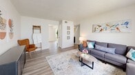 This single-story Memphis home offers four bedrooms and two bathrooms within a thoughtfully designed floor plan. The living room is bright and welcoming, featuring light wood-style flooring, a textured ceiling, and large windows fitted with vertical blinds that allow generous natural light to fill the space. The open flow connects seamlessly to the dining area, which also features the same wood-style flooring and a clean, neutral palette. The galley-style kitchen is equipped with warm honey-toned wood cabinetry, granite-style countertops, stainless steel appliances, and wood-look tile flooring, offering efficient use of space. The bedrooms are carpeted and comfortably sized, with the primary bedroom featuring a spacious layout, a large window for natural light, and a closet. The additional bedrooms share the same carpeted, neutral aesthetic. Both bathrooms include a tub-shower combination with tiled surrounds — one with warm wood vanity cabinetry and the other with accessibility-friendly features including a grab bar. A connecting hallway ties the layout together efficiently. The home's clean, light-toned interior creates a comfortable and practical living environment throughout.