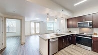 Located at 3100 Purcell St in Richmond, Virginia, this well-designed single-floor residence offers three bedrooms and three bathrooms within a thoughtfully laid-out floor plan. Durable hardwood-style flooring runs consistently throughout, creating a cohesive and modern aesthetic across every room.

The kitchen serves as a central highlight, featuring rich dark cabinetry, light quartz countertops, a peninsula with an undermount sink, and a full suite of stainless steel appliances including a refrigerator, range, microwave, and dishwasher. Pendant lighting above the peninsula adds a polished finishing touch.

The open living area is bathed in natural light through multiple windows and provides direct access to a private balcony through a set of glass French doors, extending the living space outdoors. Each of the three bedrooms is generously proportioned, with large windows offering neighborhood views and ample wall space. The primary bedroom provides a comfortable and private retreat.

The three bathrooms are clean and functional, finished with light tile flooring, dark wood vanities, and tub-shower combinations fitted with brushed nickel fixtures. A connecting hallway ties the layout together efficiently. This residence combines modern finishes with practical design, making it a well-appointed home in Richmond's 23223 neighborhood.