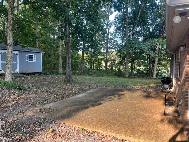 Back patio entrance view & storage building - 660 Rogers Ln