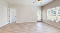 Located at 150 E Forest Park Dr in Dickson, Tennessee, this well-appointed 2-bedroom, 3-bathroom single-floor residence offers a thoughtfully designed layout with a clean, contemporary aesthetic. The open-concept kitchen and living area serves as the heart of the home, showcasing white shaker cabinetry, dark granite countertops, a peninsula with a built-in sink, stainless steel appliances including an electric range, microwave, and refrigerator, along with a tile backsplash and pendant lighting. Light hardwood-style flooring flows throughout the main living and kitchen areas, complemented by neutral warm-toned walls that create a bright, inviting atmosphere. The living room features a ceiling fan with light fixture and an exterior door providing natural light and outdoor access. Both bedrooms are carpeted and generously sized, each equipped with ceiling fans and large windows dressed with blinds that offer views of surrounding greenery. The primary bedroom provides a comfortable, private retreat. The three bathrooms are well-finished, featuring tub-shower combinations with classic white subway tile surrounds, brushed nickel hardware, and light hardwood-style flooring. Two closets provide ample storage throughout the residence. The overall design emphasizes clean lines, neutral finishes, and functional living spaces.