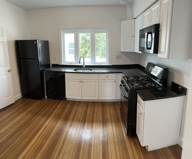 Updated kitchen. All stainless steel appliances, Brazilian granite countertop, Shaker cabinets - 58 S Waverly St