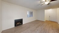 Located at 3573 Columbia Ave in Riverside, CA, this single-story 2-bedroom, 2-bathroom residence offers a well-organized and efficiently designed layout. Light-toned hardwood-style flooring flows throughout the entire home, lending a clean, cohesive aesthetic to every room.

The open-concept living and dining area serves as the heart of the home, featuring a cozy fireplace, a ceiling fan, and a sliding glass door that opens to a private patio, filling the space with natural light and providing outdoor access. A pass-through counter connects the living area to the kitchen, which is well-appointed with white shaker-style cabinetry, gray stone countertops, a tray ceiling with recessed lighting, a gas range, stainless steel microwave, black dishwasher, and matching refrigerator.

Both bedrooms are comfortably sized with sliding-door closets, neutral walls, and textured ceilings. The primary bedroom offers generous proportions and easy access to a full bathroom. The two bathrooms are finished in a clean, minimal style with white vanities, brushed nickel fixtures, and tub-shower combinations. Additional features include multiple closets for ample storage, two hallways, an in-unit laundry area, and two utility rooms, rounding out this functional and move-in-ready home.