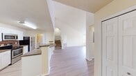 This contemporary townhome at MacAlpine Place offers a well-designed living space across two floors. The ground level, spanning 1100 sq ft, hosts an open-concept kitchen and living area. The kitchen boasts white cabinetry, granite countertops, and stainless steel appliances, including a built-in microwave. Light wood-look flooring throughout enhances the bright, airy feel of the space.

Upstairs, the 430 sq ft second floor accommodates two bedrooms, including a primary bedroom of 180 sq ft. Both bathrooms feature granite vanity tops and wood-look flooring. The home is equipped with ceiling fans in the bedrooms for added comfort.

Storage is abundant with three closets, including walk-in closets with wire shelving systems. A dedicated laundry room adds convenience to daily living. The neutral color palette and clean lines create a modern aesthetic, while the open layout and ample natural light contribute to a sense of spaciousness throughout the home.
