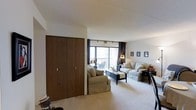 Located at 30 Severance Circle in Cleveland Heights, Ohio, this single-floor residence offers a thoughtfully arranged layout designed for comfortable everyday living. The living room serves as the heart of the home, featuring plush carpeting, a large sliding glass door that opens to a private balcony, and generous natural light that fills the space throughout the day. Track lighting and neutral wall tones contribute to a bright, welcoming ambiance. A set of warm wood-toned bifold closet doors provides substantial storage directly within the living area, adding both function and a classic mid-century character to the room. The kitchen is centrally positioned and well-equipped, with cabinetry in warm wood finishes and a practical layout that connects naturally to the adjacent dining area, which comfortably accommodates a full dining set. The bedrooms are well-proportioned and continue the carpeted flooring found throughout the home, each offering closet storage. A dedicated bathroom serves the unit with functional fixtures. The overall floor plan flows intuitively from room to room, making the space feel cohesive and efficient. The combination of natural light, classic finishes, and a well-connected layout makes this Cleveland Heights residence a highly functional and comfortable home.