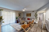 Located at 931 S Helena Way in Aurora, CO, this single-floor, 2-bedroom, 1-bathroom home offers a well-designed layout that maximizes comfort and functionality. The open-concept living room is a welcoming centerpiece, featuring wood-style flooring, a ceiling fan with light, and a sliding glass door with vertical blinds that floods the space with natural light and provides access to an outdoor area. The kitchen is thoughtfully appointed with white upper cabinetry, gray lower cabinets, a subway tile backsplash, marble-style countertops, and stainless steel appliances including a refrigerator, electric range, microwave, and dishwasher. A dining area adjacent to the kitchen provides space for everyday meals. Both bedrooms are carpeted and offer a calm, restful atmosphere. The spacious primary bedroom includes a ceiling fan, a closet, and direct access to the shared bathroom. The second bedroom is comfortably sized with its own closet. The full bathroom features a combined tub and shower, a vanity with gray cabinetry, and wood-style flooring. Neutral tones and textured ceilings throughout give the home a cohesive, move-in-ready feel.