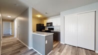 Located at 1919 Georgesville Sq in Galloway, Ohio, this single-floor unit offers a well-designed, open-concept layout that connects the living and kitchen areas seamlessly. Wood-look plank flooring runs throughout the entire space, providing a cohesive and contemporary feel.

The kitchen is equipped with dark lower cabinetry paired with white upper cabinets, granite-style countertops, and black appliances including a full-size refrigerator, range, and over-the-range microwave. A peninsula with a granite countertop extends into the living area, offering additional prep and dining space.

The living area is generously sized with a ceiling fan and a sliding glass door that allows abundant natural light to fill the room. Adjacent to the kitchen is a flexible area with a ceiling fan and closet storage, ideal for use as a dining space or additional living area.

The bedrooms are comfortably sized, each featuring ceiling fans, wood-look flooring, and ample natural light from windows with blinds. Closet space is well-provided, with some bedrooms offering double closets with built-in shelving and hanging rods.

The bathrooms are clean and functional, featuring white vanities with updated fixtures, framed mirrors, and wood-look flooring. One bathroom includes a full tub/shower combination, while another offers a standalone vanity configuration.