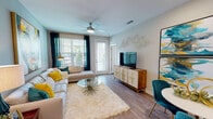 This thoughtfully designed one-bedroom, one-bathroom residence offers a single-level layout that maximizes functionality and style. Wood-style flooring flows throughout the home, providing a warm, cohesive foundation for every room.

The open-concept living area is bright and welcoming, benefiting from large windows and a glass door that invite abundant natural light and provide outdoor views. A ceiling fan adds comfort, while the generous layout accommodates both a living and dining area with ease.

The kitchen is well-equipped with stainless steel appliances, including a French door refrigerator, electric range, and built-in microwave. White cabinetry with brushed nickel hardware pairs with grey quartz-style countertops, and a kitchen island with bar seating serves as a central gathering point. Pendant lighting and a tile backsplash add refined detail. A stacked in-unit washer and dryer is conveniently located nearby.

The bedroom is a calm retreat, featuring a window with outdoor views, a ceiling fan, and direct access to the bathroom. A bold accent wall adds a distinctive design element.

The bathroom offers a single vanity with ample cabinet storage, grey countertops, and a full tub-shower combination, finished with wood-style flooring throughout.