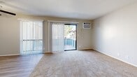 Located at 925 S Riverside Ave in Rialto, California, this 2-bedroom, 2-bathroom residence offers a practical and comfortable single-floor layout. The open-concept living, dining, and kitchen area forms the heart of the home, with carpet flooring in the living space, a ceiling fan, and a sliding glass door that opens to a private balcony—bringing in natural light and outdoor views. A wall-mounted AC unit provides climate control throughout the living area.

The galley-style kitchen is efficiently designed with white cabinetry, granite-style countertops, a double stainless steel sink, and black appliances including a range, dishwasher, refrigerator, and microwave. Light wood-style flooring runs through the kitchen and hallway, creating a clean visual transition between spaces.

Both bedrooms feature neutral carpet, ample natural light, and dedicated closets—four closets total provide generous storage throughout the home. The primary bedroom includes its own closet access and serene ambiance.

The two bathrooms are finished with granite-style countertops and light wood flooring. One bathroom features a full tub/shower combo with clean white surrounds, while the second is a more compact layout ideal for guests. The hallway connects all areas efficiently, completing this well-appointed and move-in-ready residence.