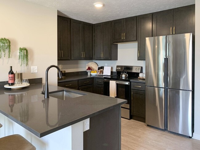 Our kitchens provide plenty of counter space and cabinetry, making meal prep and storage simple. - The Knock Apartments