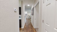 Located at 2945 Elam Rd in Murfreesboro, Tennessee, this single-floor residence offers a thoughtfully designed layout with 2 bedrooms, 2 bathrooms, a living room, dining room, kitchen, laundry room, utility room, and multiple closets throughout. Rich wood-look flooring flows through the main living areas, hallways, kitchen, and bathrooms, creating a cohesive and polished aesthetic.

The kitchen is a standout feature, showcasing dark espresso cabinetry, light granite countertops, stainless steel appliances, and a double sink — all finished with crown molding for an elevated feel. It opens directly to the dining area, fostering a connected and functional space ideal for everyday living.

The living room is warm and inviting, with crown molding, a ceiling fan, and a glass door that fills the room with natural light and provides outdoor access. Both bedrooms are carpeted and generously sized, with the spacious primary bedroom offering comfortable proportions and direct access to its own bathroom. Each bathroom is outfitted with dark vanity cabinetry, granite countertops, and wood-look flooring, maintaining consistent design quality throughout.

A dedicated laundry room with washer and dryer hookups and overhead shelving adds practical convenience. The hallways connect all areas efficiently, completing a well-organized and functional floor plan.