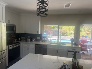 shared kitchen in the house with pool/hot tub in background - 7073 Mewall Dr