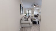 Located at 13330 West Rd in Houston, TX, this single-story 2-bedroom, 2-bathroom home offers a thoughtfully designed layout across a comfortable footprint. The open-concept living and dining area serves as the heart of the home, featuring light wood-look flooring, crown molding, and a ceiling fan that enhances the bright, airy atmosphere. Large windows dressed with sheer curtains allow generous natural light to fill both the living and dining spaces. The dining area accommodates a full-sized table and benefits from additional window views.

The galley-style kitchen is well-equipped with warm wood cabinetry, granite countertops, stainless steel appliances, and ample storage throughout. Both bathrooms mirror the kitchen's granite countertops and include tub-shower combinations with clean white tile surrounds.

The spacious primary bedroom features plush carpeting, a ceiling fan, and windows with soft drapery, creating a serene retreat. It includes dedicated closet space for storage. The second bedroom is equally comfortable and well-proportioned. A connecting hallway with additional closets ensures practical organization throughout. The overall palette of neutral tones and consistent finishes lends the home a cohesive, welcoming ambiance.