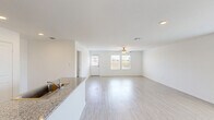 Located in a quiet New Braunfels, TX neighborhood, this single-story, 4-bedroom, 2-bathroom home offers a thoughtfully designed layout ideal for comfortable everyday living. The open-concept main area seamlessly connects the kitchen, dining, and living spaces, all bathed in natural light from large windows. Light wood-style flooring runs throughout, complementing the home's clean, bright aesthetic with crisp white walls and a textured ceiling.

The kitchen is well-appointed with tall white cabinetry reaching the ceiling, stainless steel appliances including a gas range, built-in microwave, and French door refrigerator, as well as granite-style countertops and a stainless steel sink. A convenient pantry and laundry room add to the home's practical storage and utility options.

The spacious primary bedroom features a generous walk-in closet with built-in shelving and rods. Additional bedrooms are well-proportioned, each with closets and windows providing natural light. The bathrooms are clean and functional, featuring tub/shower combinations.

A central hallway connects the bedroom wing to the main living areas. The home also includes an attached garage. Outside, the property sits on a well-maintained lot with a sizable backyard, manicured front landscaping, and street-facing curb appeal within a welcoming residential community.