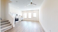 Located at 2115 Palmer Rd in Davenport, FL, this two-story home offers a well-organized layout spread across two floors. The main level hosts an open-concept kitchen and living area filled with natural light from multiple large windows. The kitchen is equipped with stainless steel appliances, including a range, microwave, and dishwasher, complemented by white shaker cabinetry, granite countertops, and a classic subway tile backsplash. Light wood-look flooring runs throughout the main level, and a ceiling fan adds comfort to the living space. Three hallways provide smooth flow between areas, while a dedicated laundry room with a full-size washer and dryer adds everyday convenience. An attached garage offers additional storage and parking. Upstairs, two bedrooms are carpeted and filled with natural light from generous windows. The spacious primary bedroom features a ceiling fan and an en-suite bathroom with granite countertops and wood-look flooring. Three bathrooms total are finished with granite vanities and brushed nickel fixtures. Each bedroom includes a dedicated closet. The home's clean, neutral palette and modern finishes create a bright and functional living environment throughout.