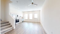 Located at 2115 Palmer Rd in Davenport, FL, this two-story home offers a well-organized layout spread across two floors. The main level hosts an open-concept kitchen and living area filled with natural light from multiple large windows. The kitchen is equipped with stainless steel appliances, including a range, microwave, and dishwasher, complemented by white shaker cabinetry, granite countertops, and a classic subway tile backsplash. Light wood-look flooring runs throughout the main level, and a ceiling fan adds comfort to the living space. Three hallways provide smooth flow between areas, while a dedicated laundry room with a full-size washer and dryer adds everyday convenience. An attached garage offers additional storage and parking. Upstairs, two bedrooms are carpeted and filled with natural light from generous windows. The spacious primary bedroom features a ceiling fan and an en-suite bathroom with granite countertops and wood-look flooring. Three bathrooms total are finished with granite vanities and brushed nickel fixtures. Each bedroom includes a dedicated closet. The home's clean, neutral palette and modern finishes create a bright and functional living environment throughout.
