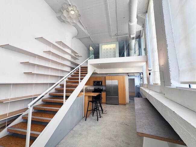 entry view with 17' high wall of bookshelves - 200 N San Fernando Rd