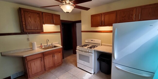 Kitchen with fresh paint, newer stove and refrigerator. - 1755 S 71st St