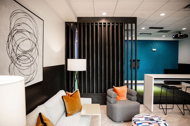 Resident Lounge Featuring Accent Wall, Bar Seating, and Relaxed Social Space - The Maggie